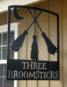 there is a sign that says three brooms on it