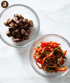 two bowls filled with meat and veggies on top of a white marble counter