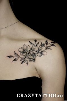 a woman's shoulder with flowers on it