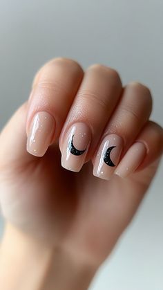 Elevate your Halloween nails with a subtle nude design featuring a black crescent moon accent. This elegant and eerie look is perfect for a chic seasonal touch. Click the pin and follow us for more stylish Halloween nail inspiration! #CrescentMoonNails #HalloweenNails #NailArtIdeas #SpookyNails #NudeNails Nude Nails Halloween, Milky Nails With Black Design, Halloween Moon Nails, Nail Moon Designs, Halloween Neutral Nails, Subtle Halloween Nail Art, Crescent Moon Nails