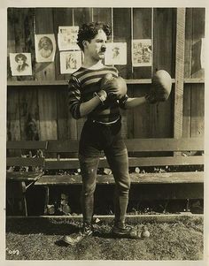 an old black and white photo of a man with boxing gloves