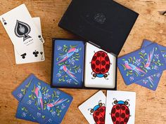 four playing cards are sitting next to each other on a table, with one card in the middle