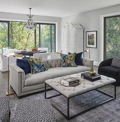 a living room filled with furniture and lots of windows