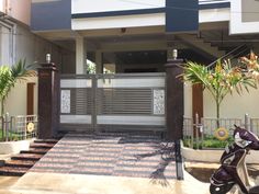 a motor scooter parked in front of a house with a gated entrance