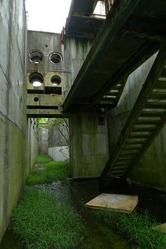 an alley way with stairs leading up and down to the top floor that is partially submerged in water