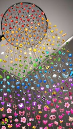 a shower head with lots of colorful buttons hanging from it