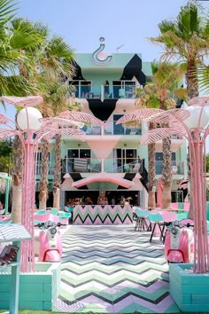 an outdoor area with tables, chairs and umbrellas