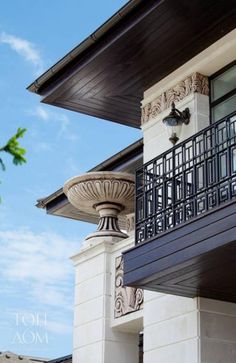 an ornate balcony and balconies on the side of a building with blue skies in the background