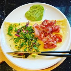 an omelet with bacon, lettuce and avocado on it