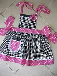 two pieces of pink and black polka dot dress with matching bow ties on the bottom