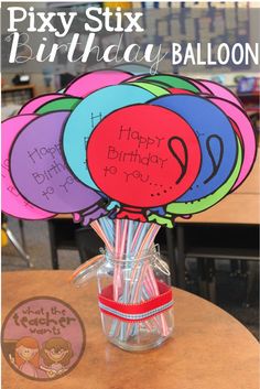 birthday balloons in a vase with the words happy birthday balloon written on them and some candy sticks sticking out of it