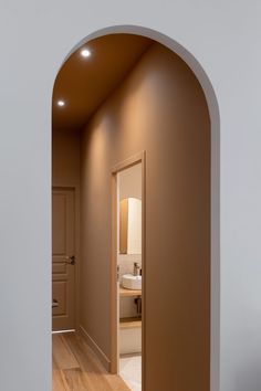 an archway leading to a bathroom with a sink