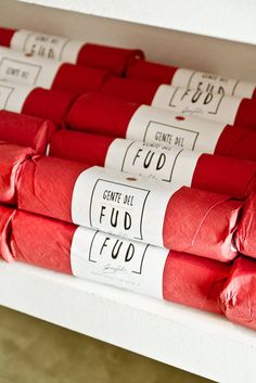 several rolls of red toilet paper are stacked on top of each other and labeled with the words, enter all fud