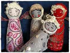 three dolls made out of cloth and fabric