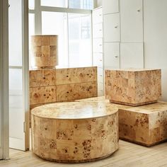 three stools made out of cork sit in the middle of a wood floored room