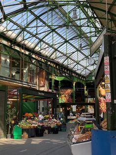 an indoor market with lots of fruits and vegetables