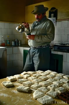 a man standing in front of a table filled with cookies