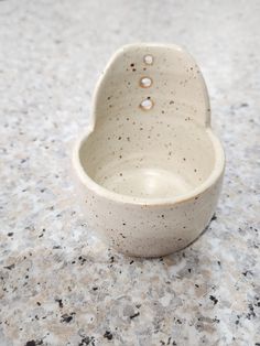 a white ceramic bowl sitting on top of a counter