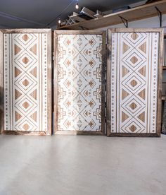 an open room divider sitting on top of a hard wood floor next to a wall