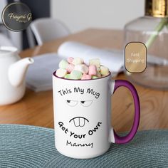 there is a coffee mug with marshmallows in it