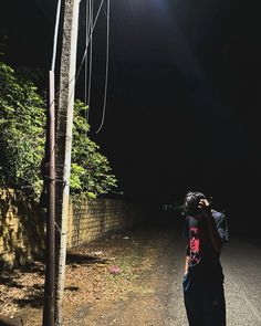 a person taking a photo on a dark road