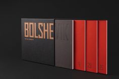 three books with black and red covers sitting on top of each other in front of a black background