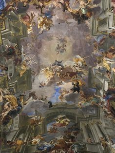 the ceiling is painted with many different paintings