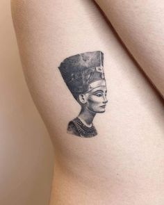 an egyptian woman's tattoo on the right thigh