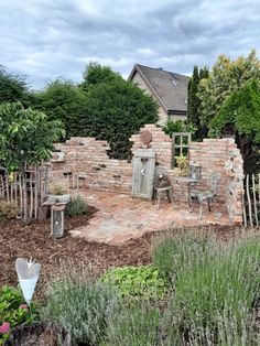 an outdoor patio with brick walls and chairs in the foreground, surrounded by greenery