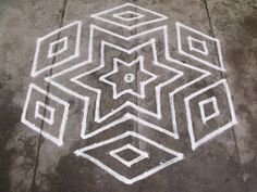 an artistic drawing on the ground with white lines and squares in the shape of a star