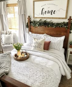 a bed with white comforter and pillows in a bedroom next to a wooden headboard