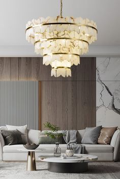 a living room with a couch, coffee table and chandelier hanging from the ceiling