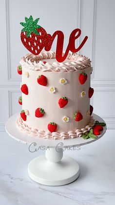 a strawberry cake with the word love spelled on top