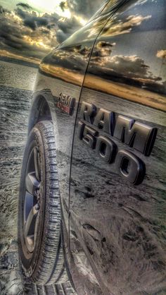 the back end of a car parked on top of a beach