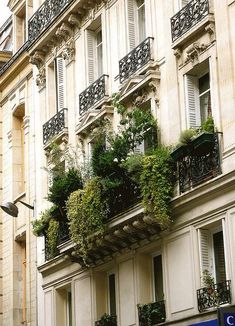 an apartment building with balconies and plants on the balconys in paris, france