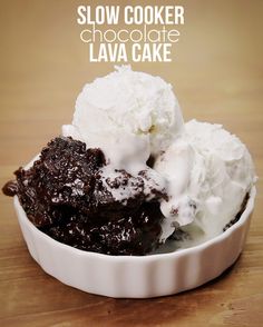 a white bowl filled with ice cream and chocolate lava cake on top of a wooden table