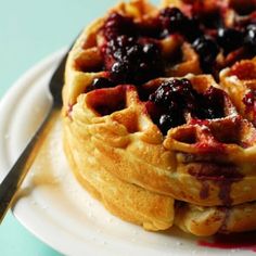 a stack of waffles sitting on top of a white plate