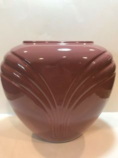 a brown vase sitting on top of a white table