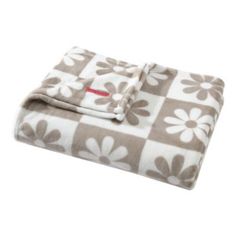 a blanket that is on top of a white and brown checkerboard pattern with flowers