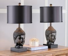 two lamps sitting on top of a wooden table