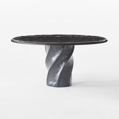 a black and white table sitting on top of a floor