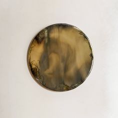 a circular object on a white wall in the shape of a circle