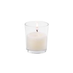 a white candle in a clear glass on a white background