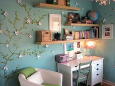 a room with a desk, chair and bookshelf on the wall in it