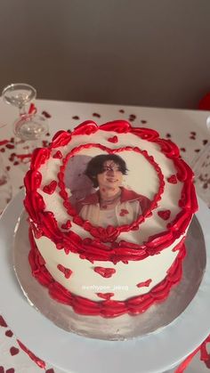 a white and red cake sitting on top of a table