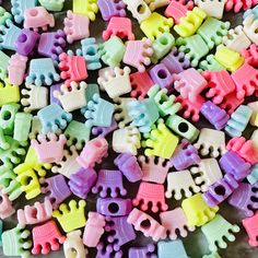 there are many different colored plastic toys on the table