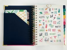 an open notebook with various stickers on it and a notepad attached to the cover