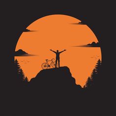 a man standing on top of a mountain with his bike