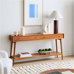 a wooden table with two drawers and a lamp on top