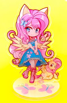 a pink and blue doll next to a small dog on a yellow background with butterfly wings